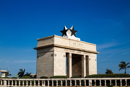 Independence Arch monument in Accra, Ghana, against a clear blue sky