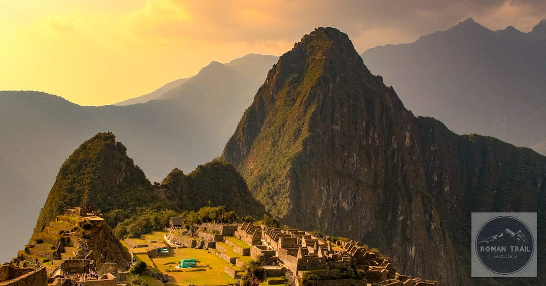 Machu Picchu citadel and Huayna Picchu peak at golden hour sunset