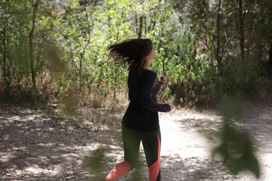 Trekking in Texas hill country wearing merino wool base layer to keep you cool and dry