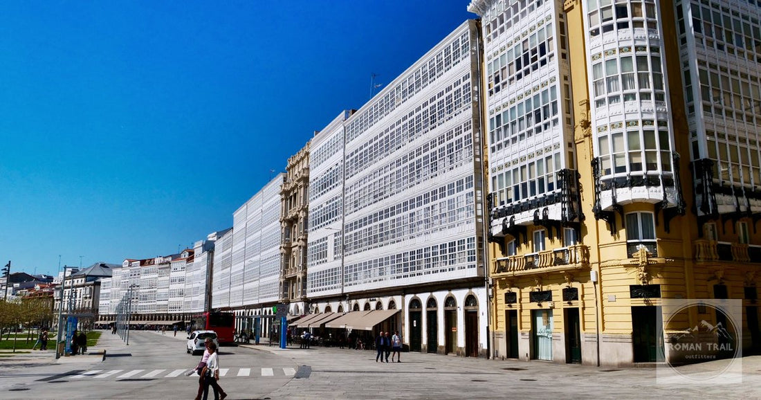 Glazed galeria balconies lining a sunny street in A Coruña, Spain