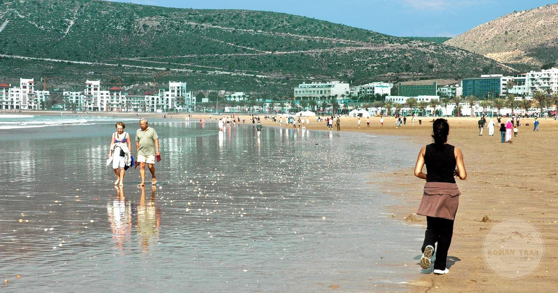 The wide sandy beach at Agadir on a sunny day, Agadir packing list for women by Roman Trail Outfitters