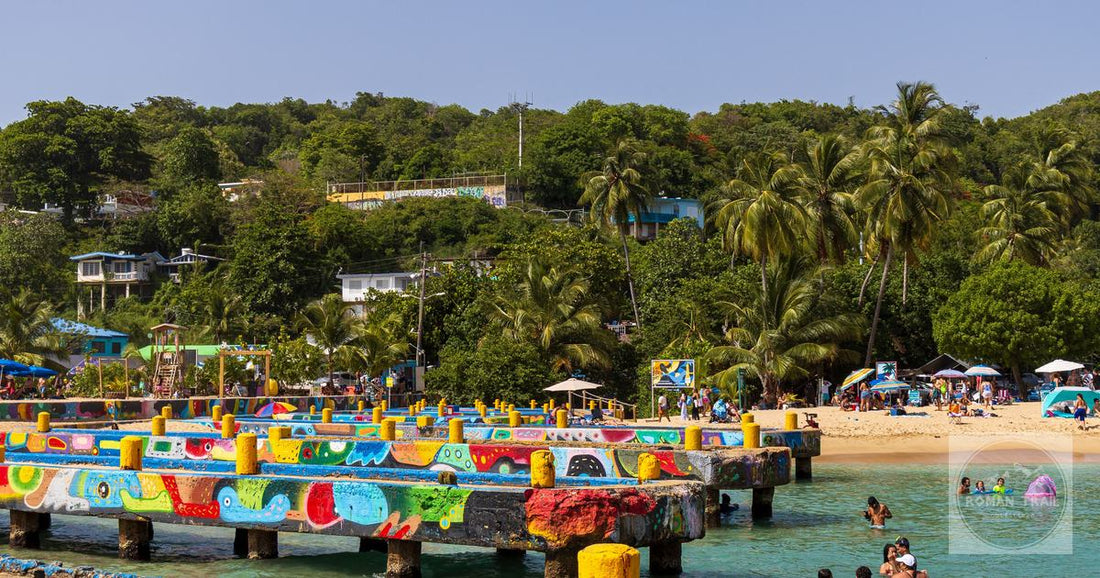 Brightly painted structures and swimmers on the beach at Aguadilla, Puerto Rico