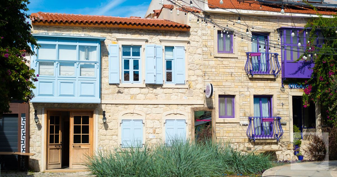 Stone houses painted in blue and purple on a street in Alacati, Izmir, Turkey