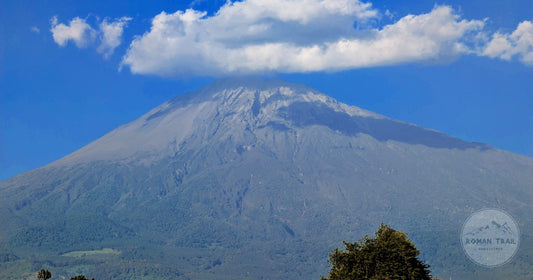Mount Meru under cloud above green country near Arusha, Arusha packing list for women by Roman Trail Outfitters