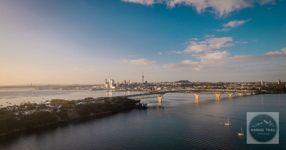 Auckland skyline and the Harbour Bridge from the air at sunset, New Zealand
