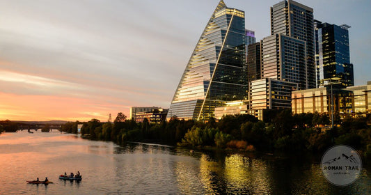 Austin skyline at sunset with kayakers on Lady Bird Lake, Austin packing list for women by Roman Trail Outfitters