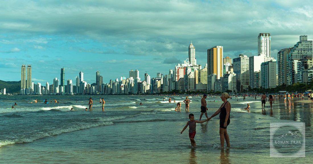 A vibrant beach scene with a modern skyline in Balneário Camboriú, Brazil.