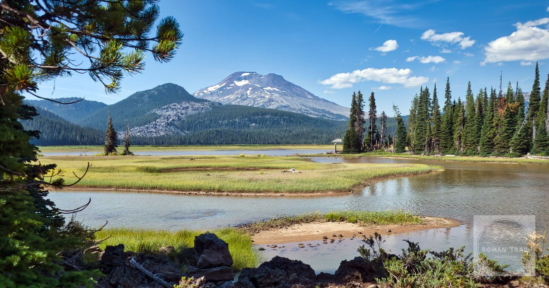 Scenic view of a tranquil lake surrounded by mountains and trees in Bend, Oregon.