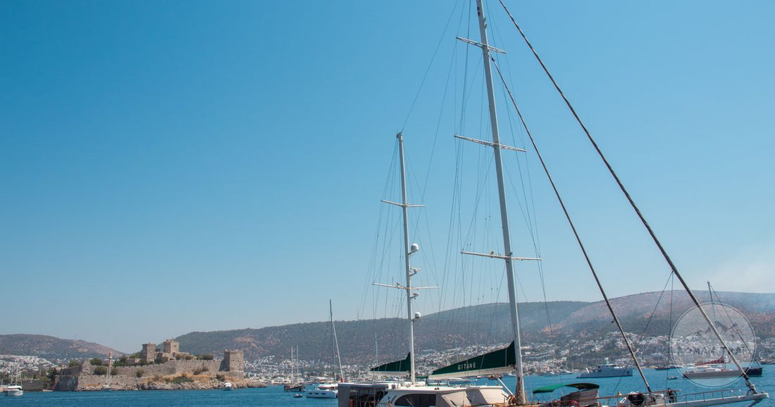 A sailboat off Bodrum with the historic Bodrum Castle behind, Mugla, Turkiye
