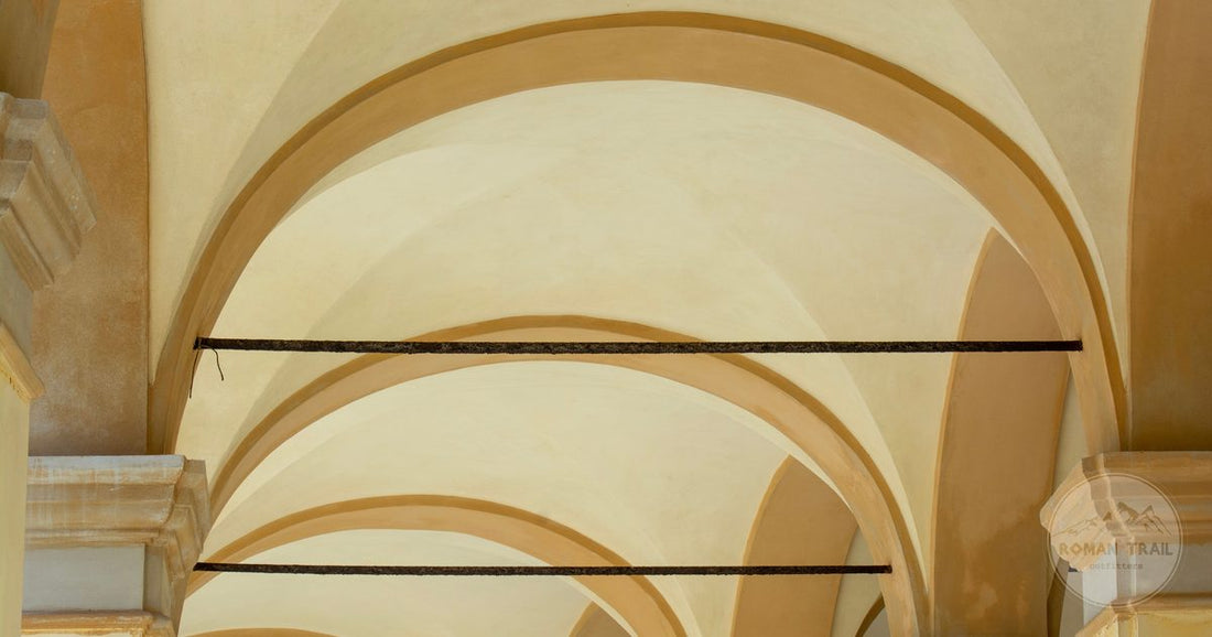 The arched porticoes of central Bologna running along a street, Bologna packing list for women by Roman Trail Outfitters