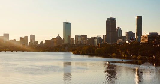 Charles River at golden hour with the Back Bay skyline behind, Boston packing list for women by Roman Trail Outfitters