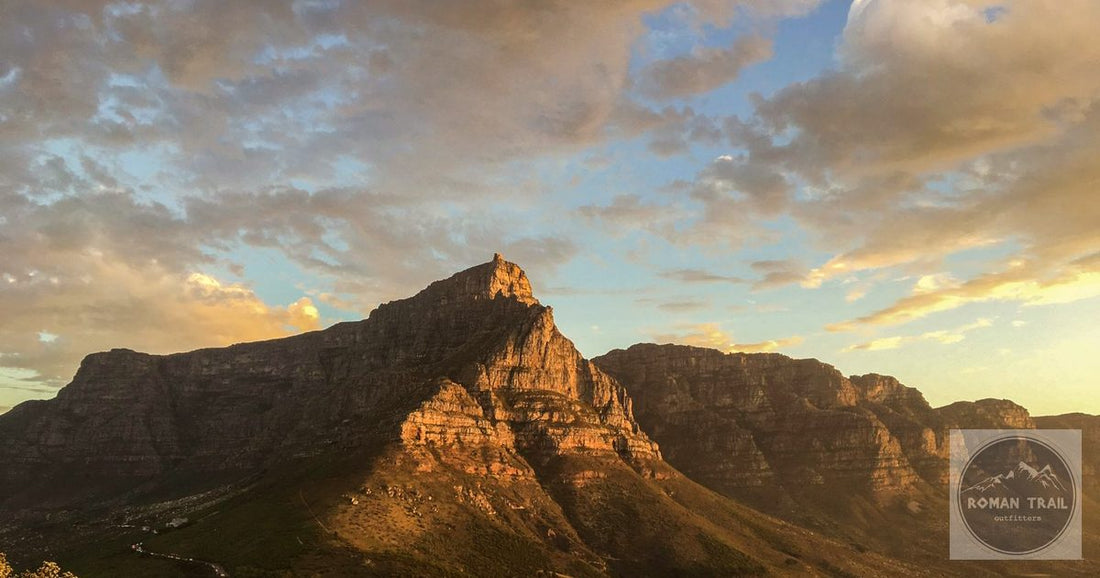 Table Mountain range at golden hour sunset, Cape Town packing list for women by Roman Trail Outfitters
