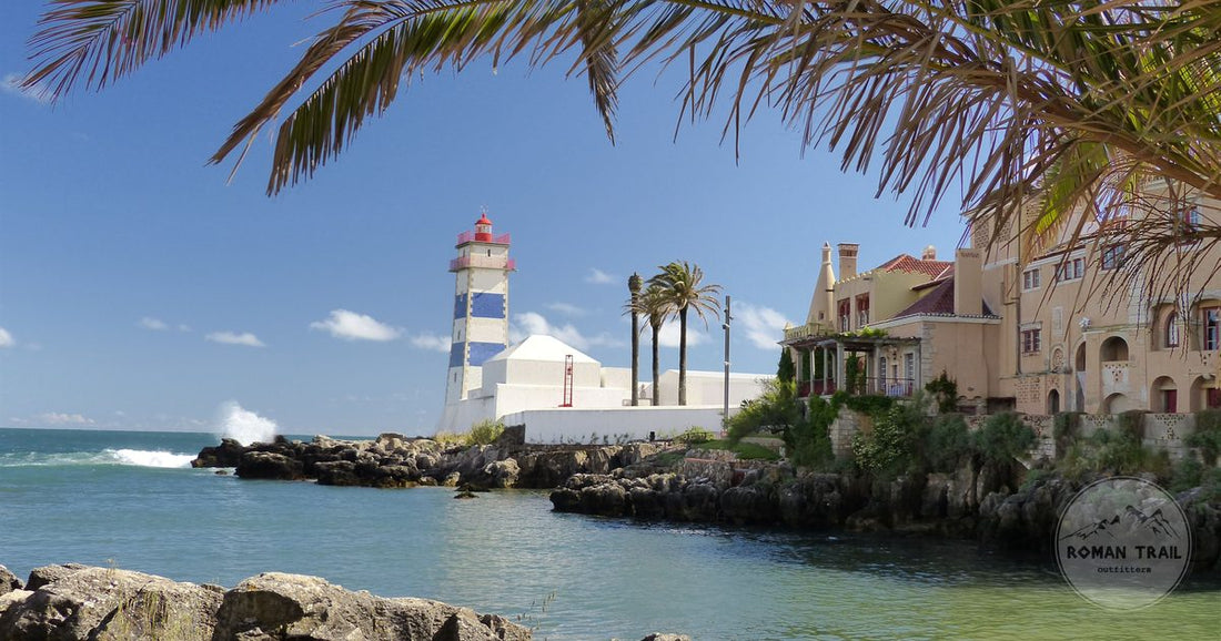 A lighthouse and historic buildings by the ocean at Cascais, Portugal