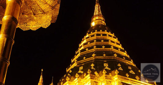 Golden chedi at Wat Phra That Doi Suthep illuminated at night, Chiang Mai packing list for women by Roman Trail Outfitters