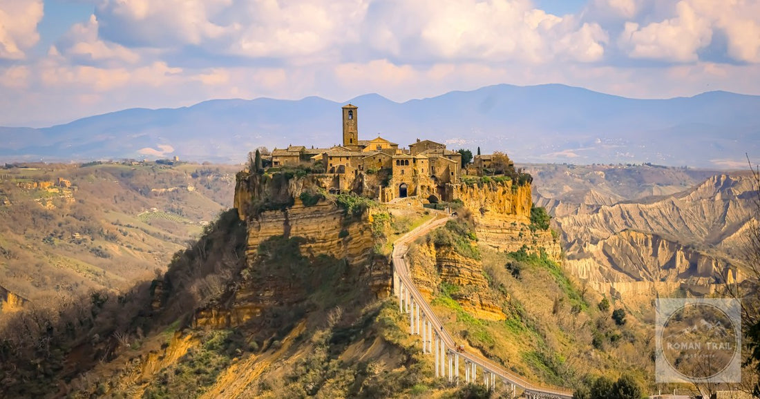 Picturesque view of historic Civita di Bagnoregio in Italy, perched atop a cliff with cloudy sky backdro
