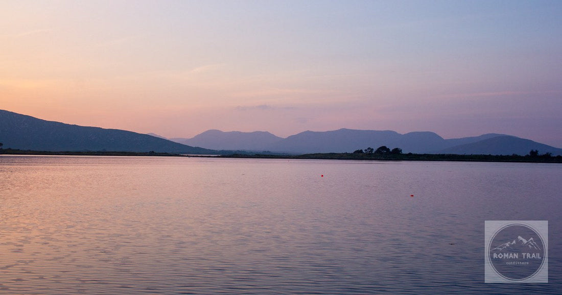 A pink sunset over a calm lake in Connemara, County Galway