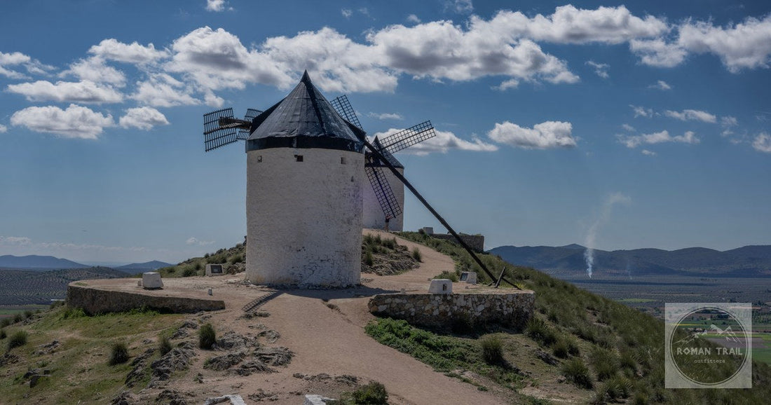 Explore the iconic windmills of Consuegra, Spain, under a beautiful blue sky.