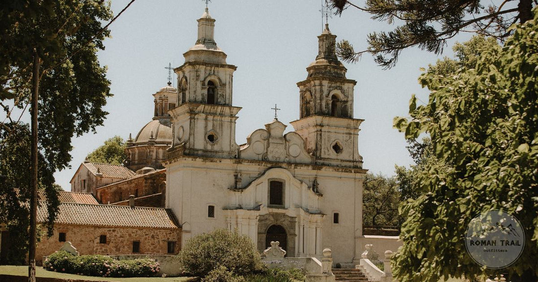 A historic colonial church surrounded by trees in Cordoba, Argentina, Cordoba Argentina packing list for women by Roman Trail Outfitters