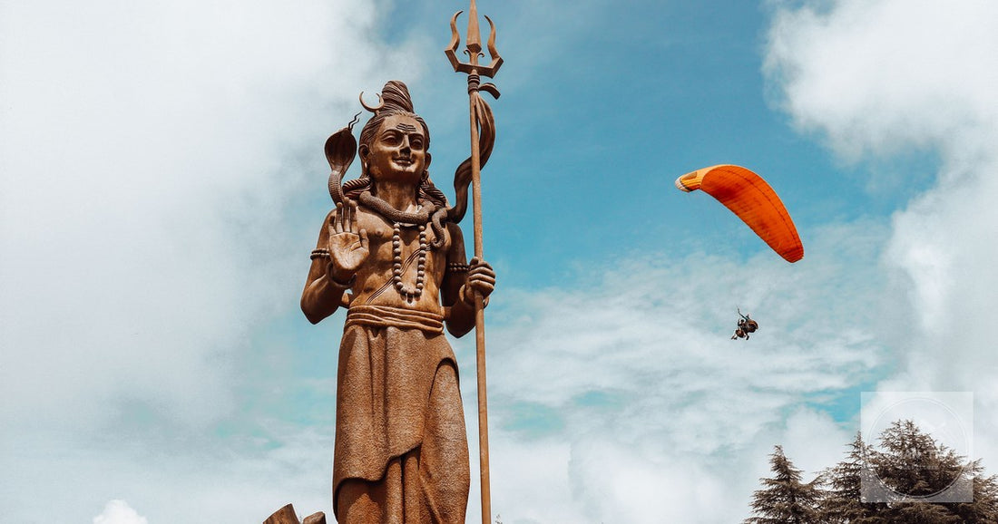 Majestic statue of Shiva with paraglider in sky, Dalhousie, India.