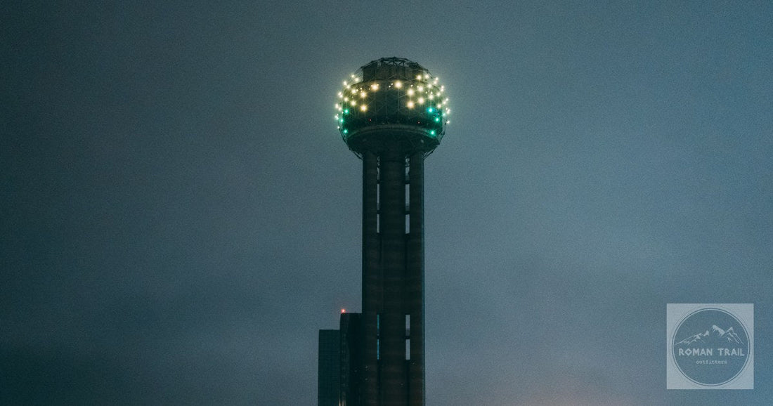 The iconic Reunion Tower glowing vividly during the night in Dallas, Texas.
