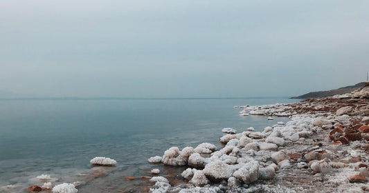 The calm mineral water and salt formations of the Dead Sea in Jordan, Dead Sea packing list for women by Roman Trail Outfitters