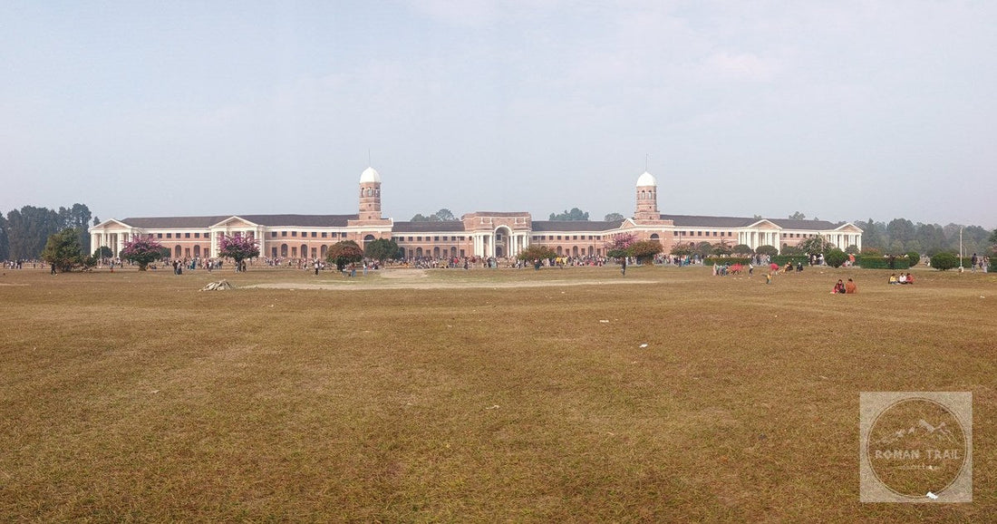 The grand facade of the Forest Research Institute in Dehradun, India, set against a clear sky.