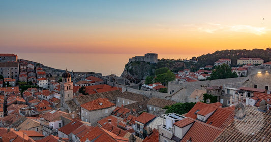 Terracotta rooftops of Dubrovnik Old Town and the Adriatic at sunset, Dubrovnik packing list for women by Roman Trail Outfitters