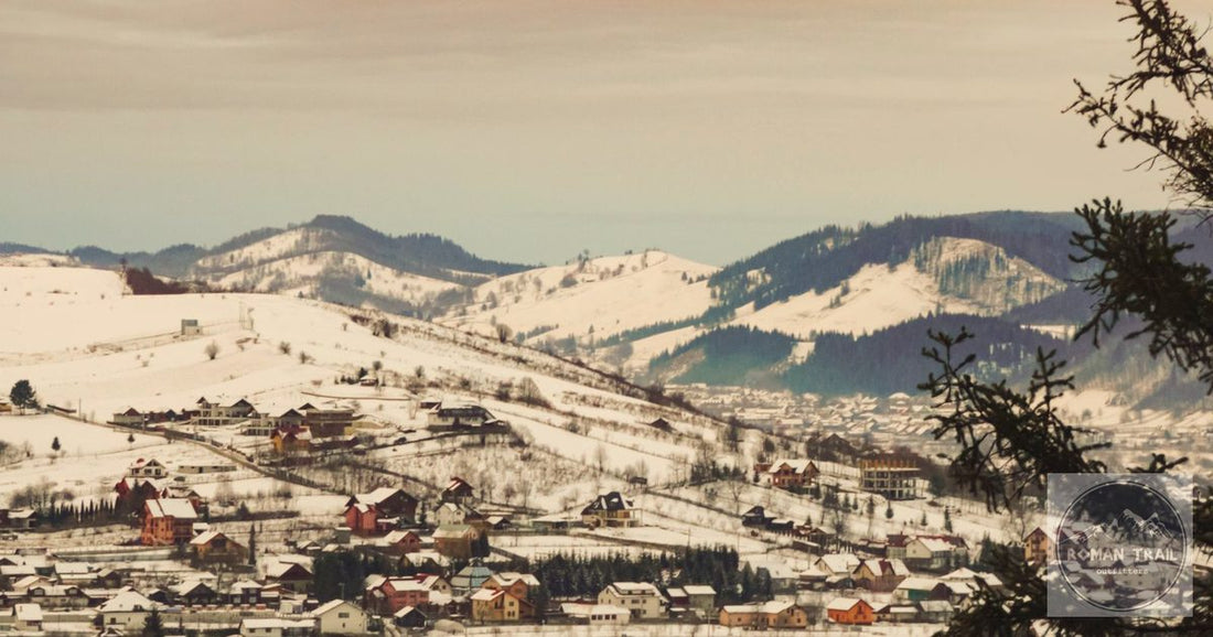 Snow-covered alpine valley village at golden hour, Europe winter packing list for women by Roman Trail Outfitters