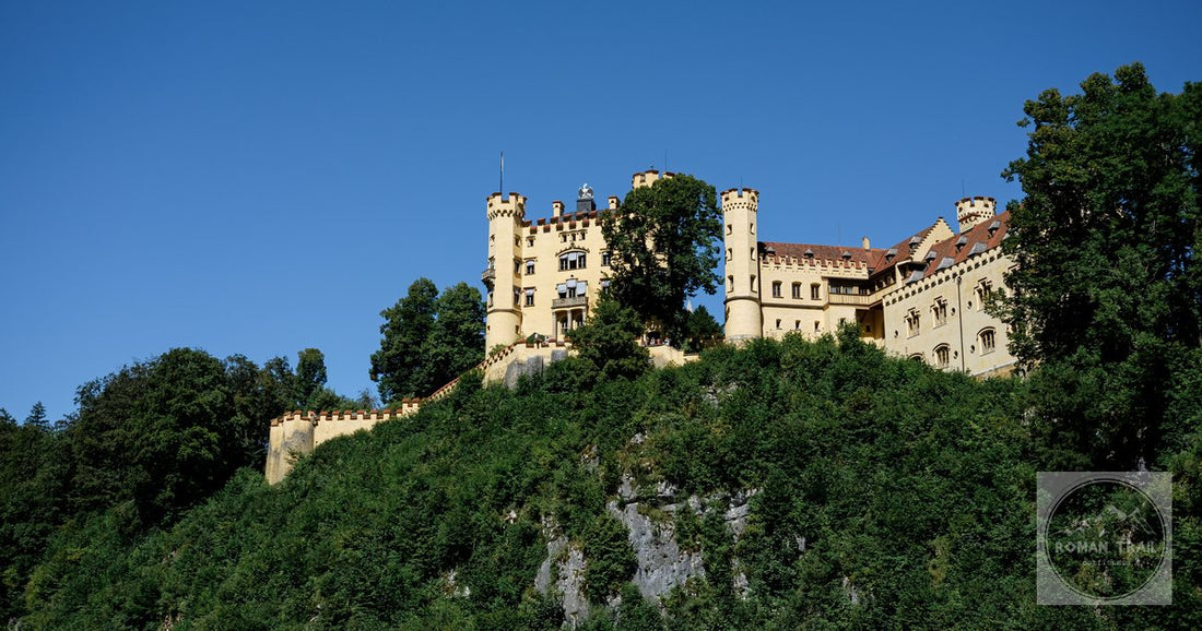 Scenic view of Hohenschwangau Castle atop a hill in Füssen, perfect for travel and architecture enthusiasts.