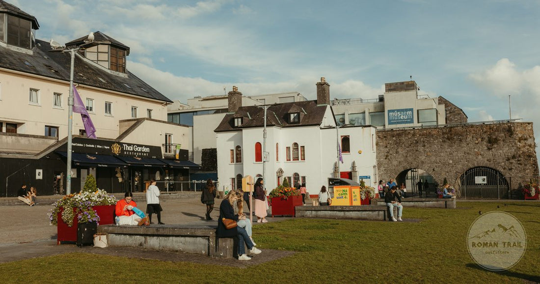 The Spanish Arch at Galway, Ireland, with people gathered by the historic buildings