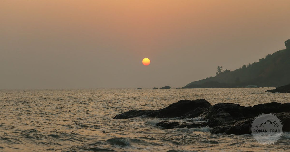 Sunset over waves on the rocky shore at Gokarna, Karnataka, India