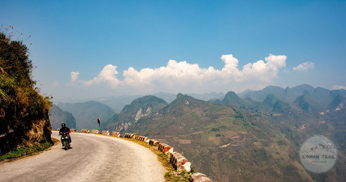 A motorcyclist on the winding road at Ma Pi Leng Pass, Ha Giang, Vietnam
