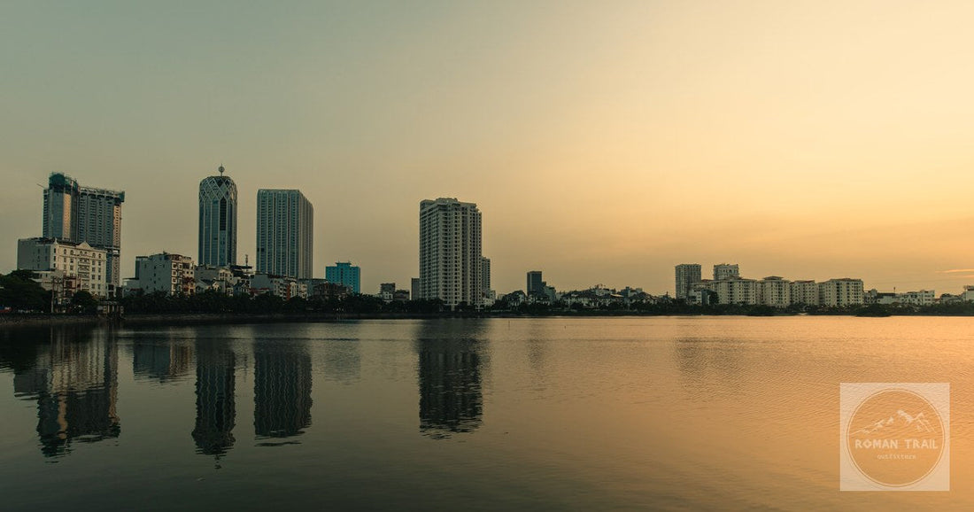 The skyline of Hai Phong reflected in calm water at dusk, Vietnam