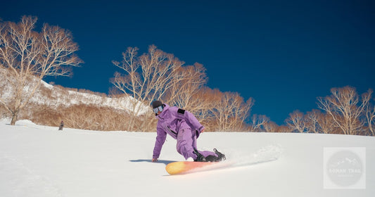 A snowboarder turning through fresh snow at Hakuba, Nagano, Japan