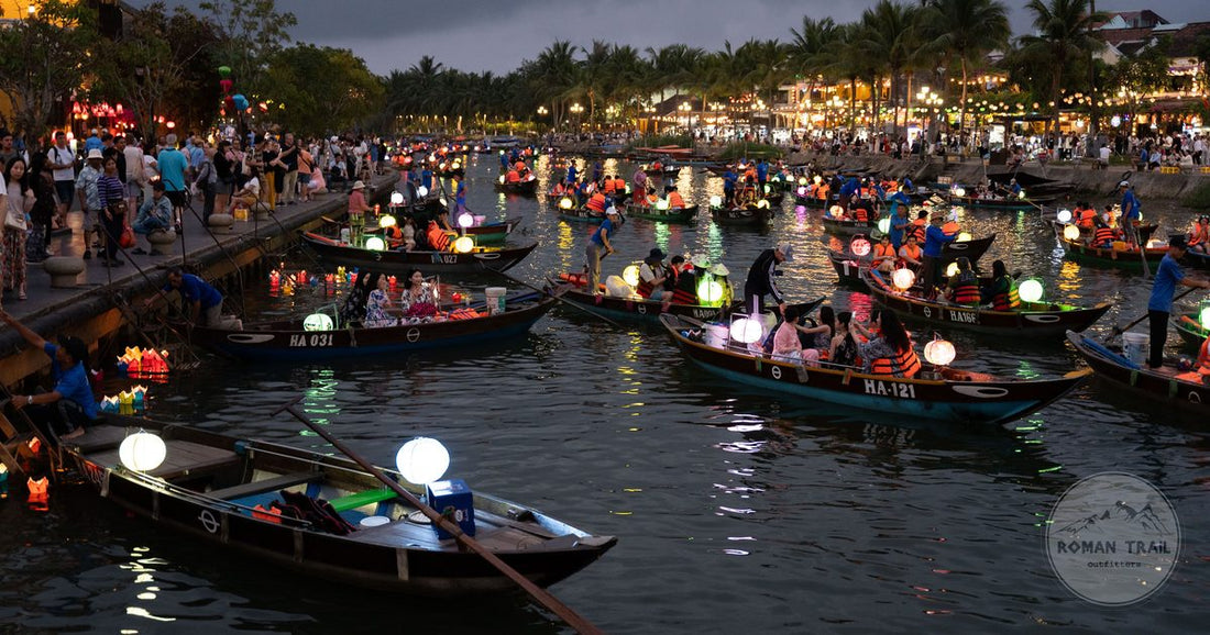 Lantern lit boats on the Thu Bon River during the Full Moon Lantern Festival, Hoi An packing list for women by Roman Trail Outfitters