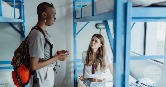Travellers talking in a hostel dormitory