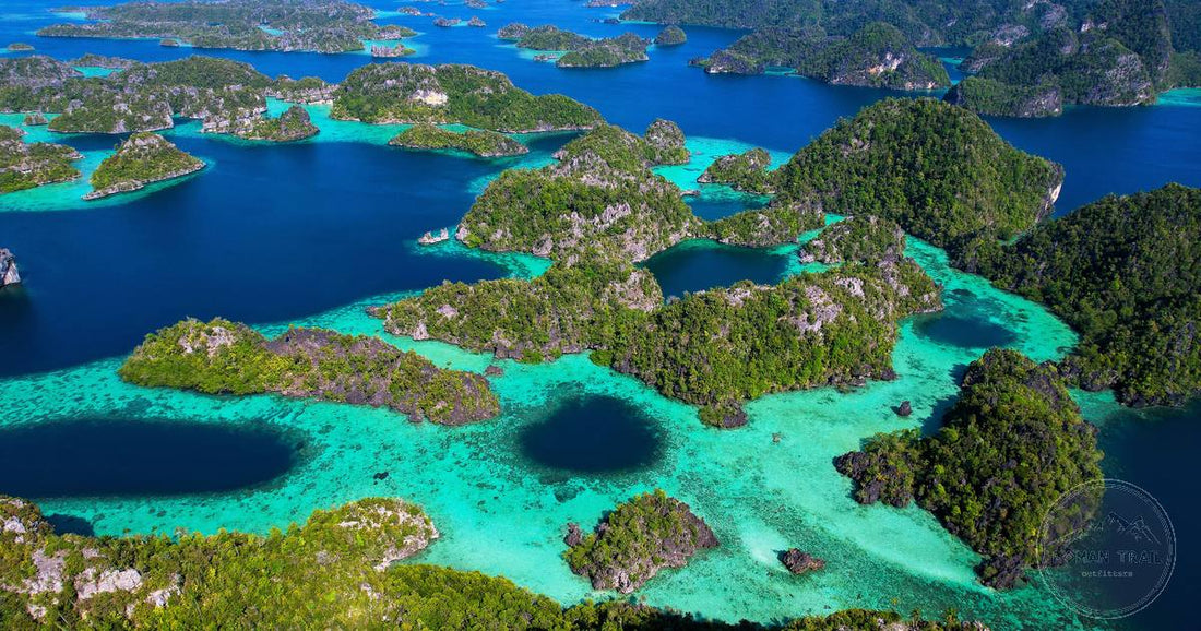 Aerial view of turquoise lagoons and limestone islands in Raja Ampat, Indonesia