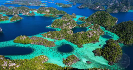 Aerial view of turquoise lagoons and limestone islands in Raja Ampat, Indonesia