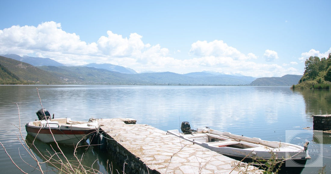 Motorboats on the pier at Lake Ioannina with mountains behind, Greece