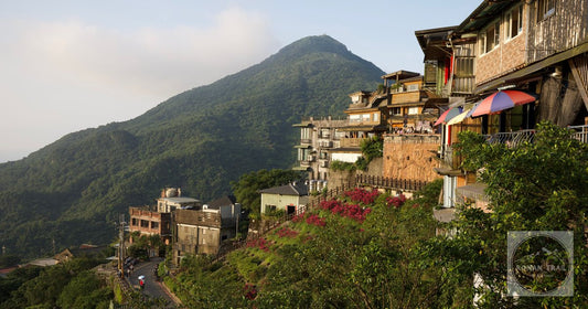 Jiufen stacked up its hillside above the sea in daylight, a former gold mining settlement north east of Taipei.