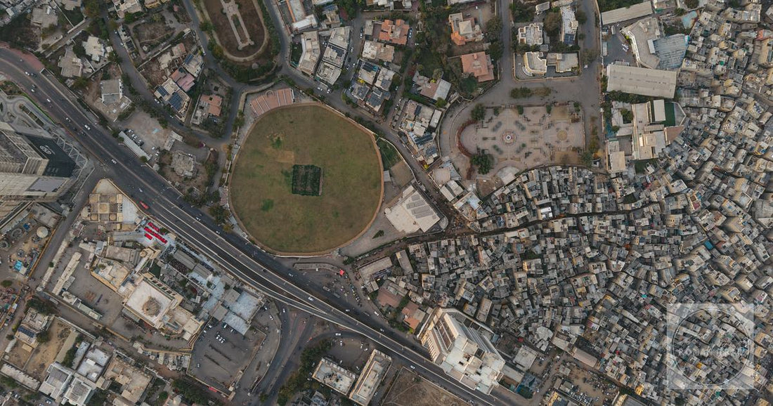 An aerial view of dense settlements and a circular park in Karachi, Pakistan