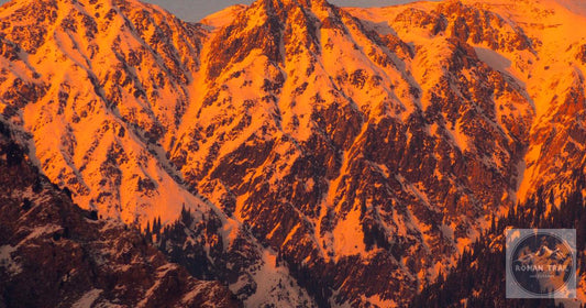 Golden hour alpenglow on Tian Shan mountains near Almaty, Kazakhstan packing list for women by Roman Trail Outfitters