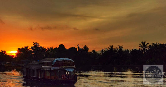 Kerala backwaters kettuvallam houseboat silhouette at golden sunset, featured image for a Kerala packing list for women