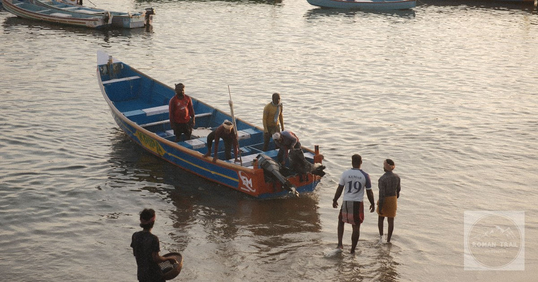 Fishermen arriving with the morning catch at Kovalam beach, Kerala, India
