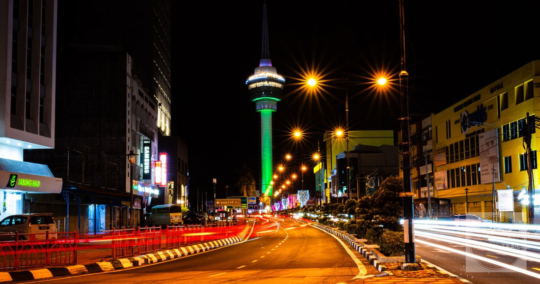 The Kuantan 188 Tower lit at night above the city streets, Malaysia