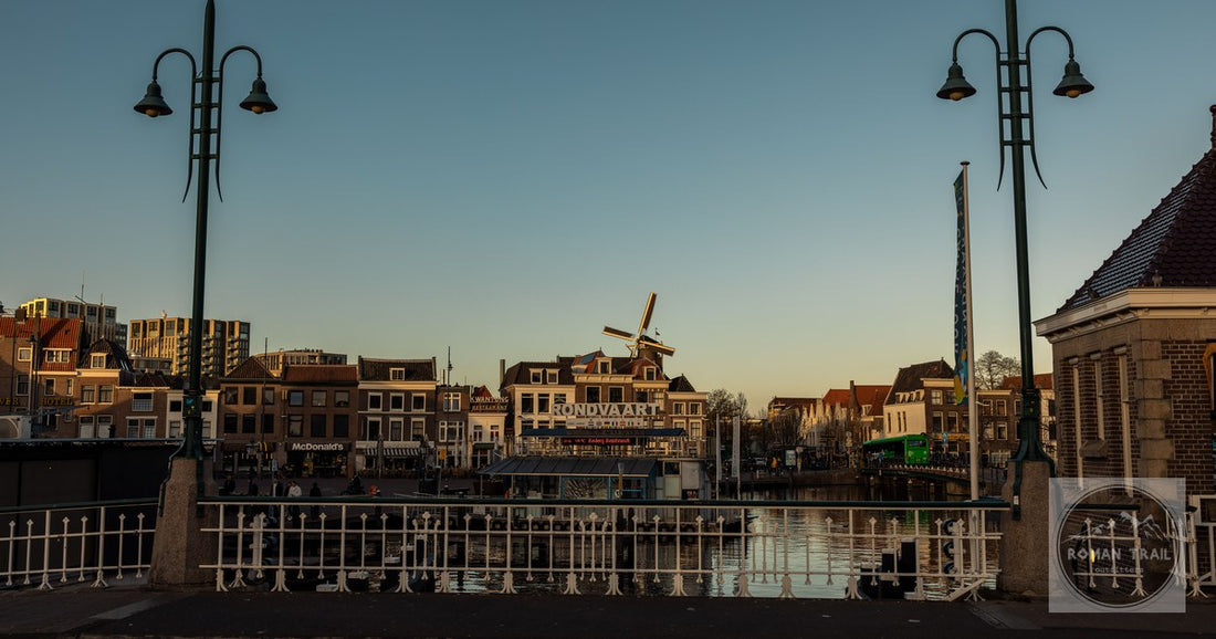 A canal, bridge and windmill at twilight in Leiden, Netherlands