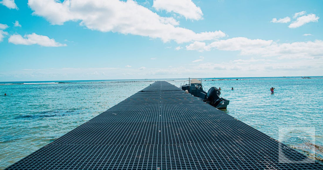 Serene pier stretching into the ocean under a bright blue sky in Mahahual, Mexico.