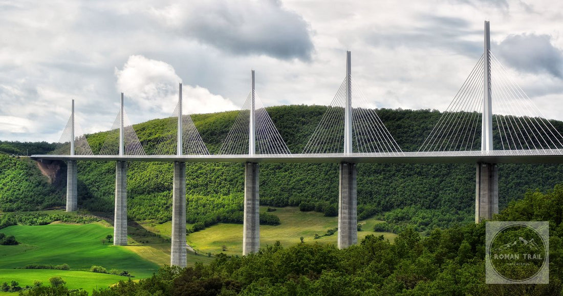 Stunning aerial view of the Millau Viaduct bridge spanning a lush green valley in southern France.
