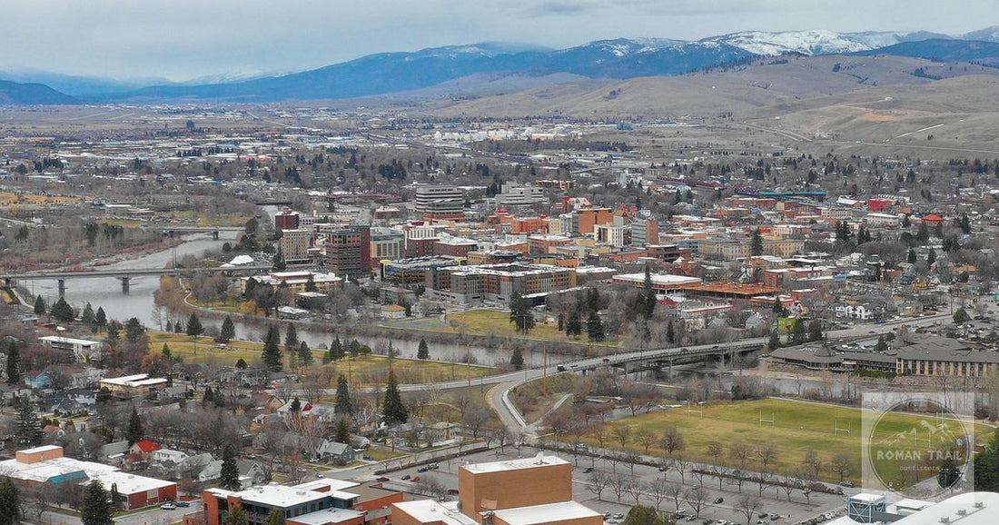 Downtown Missoula on the Clark Fork river below snow dusted mountains, Montana