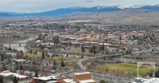 Downtown Missoula on the Clark Fork river below snow dusted mountains, Montana